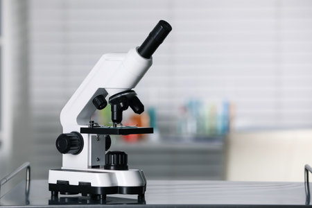 Modern medical microscope on metal table in laboratory, space for textの写真素材