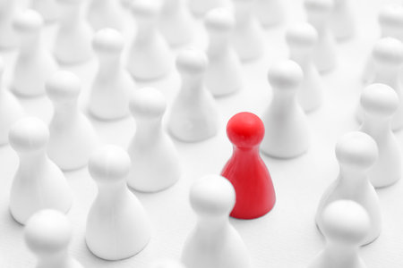 Red pawn among others on white background, closeup. Recruiter searching employeeの写真素材