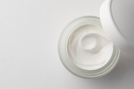Jar of face cream on white background, top view. Space for textの写真素材
