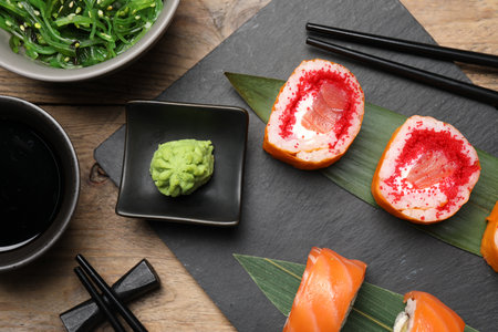 Flat lay composition with delicious sushi rolls on wooden tableの写真素材