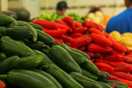 Heap of fresh green Serrano peppers on counter at market, closeup. Space for textの写真素材