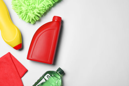 Bottles, cloth and car wash mitt on white background, flat lay. Space for textの写真素材