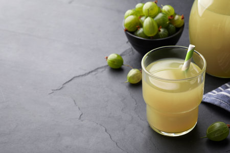 Tasty gooseberry juice on black table. Space for textの写真素材