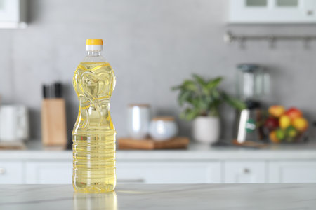 Bottle of cooking oil on white marble table in kitchen. Space for textの写真素材