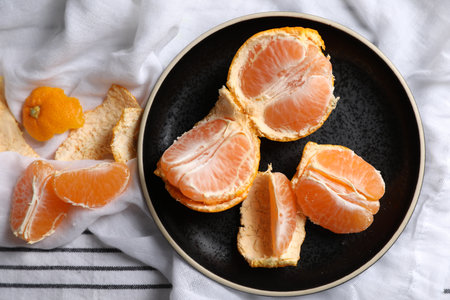 Fresh ripe tangerines on striped cloth, flat layの写真素材