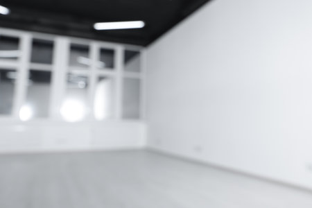 Blurred view of new empty room with windowsの写真素材