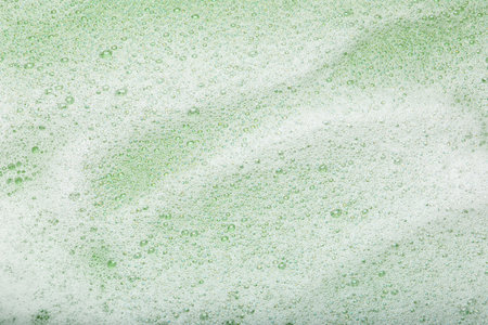White washing foam on olive background, top viewの写真素材