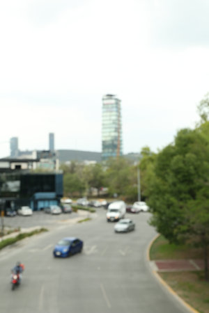 Modern cars on road near trees and building, blurred viewの写真素材