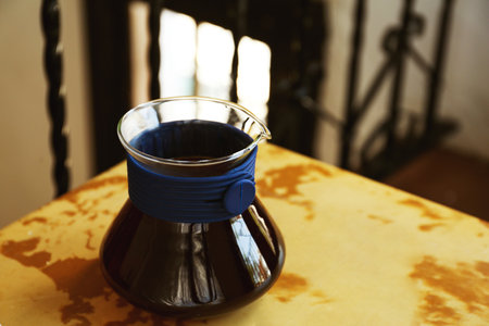 Cup of aromatic coffee on wooden table in cafeの写真素材