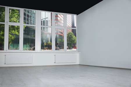 Empty office room with black ceiling and clean windows. interior designの写真素材