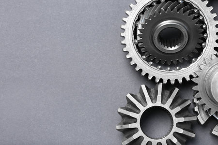 Many different stainless steel gears on gray background, flat lay. Space for textの写真素材