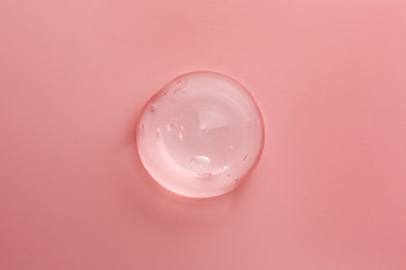 Sample of transparent gel on pink background, top viewの写真素材
