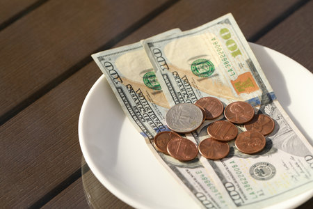 Saucer with payment for order on table, closeup. Leave tipの写真素材