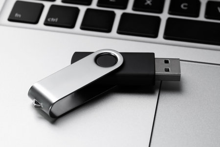 Modern usb flash drive on laptop, closeupの写真素材