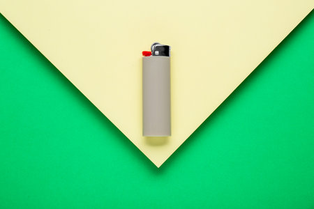 Stylish small pocket lighter on color background, top viewの写真素材