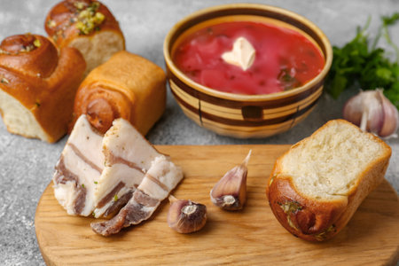 Delicious pampushky (buns with garlic) and salo served for borsch on gray textured table. Traditional Ukrainian cuisineの写真素材