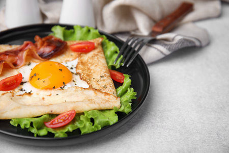 Delicious crepe with egg served on light gray table, closeup. Breton galetteの写真素材