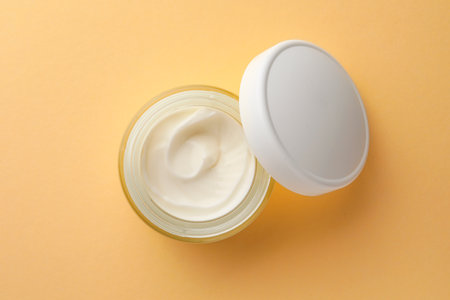 Jar face cream on beige background, top viewの写真素材