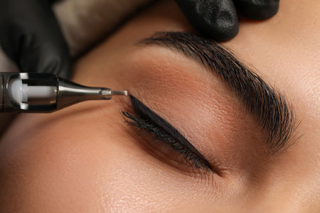 Young woman undergoing procedure of permanent eyeliner makeup, closeupの写真素材