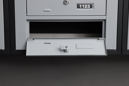 Open empty metal mailbox with keyhole indoorsの写真素材