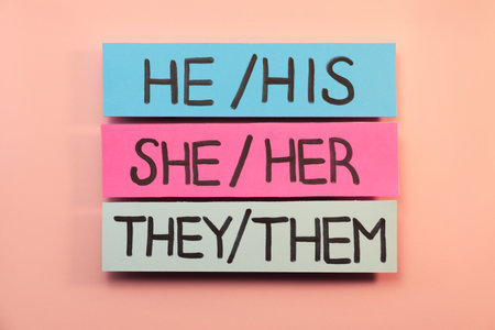Sheets of paper with pronouns on pink background, flat lay. gender equalityの写真素材