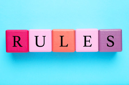 Word Rules made of colorful cubes with letters on light blue background, flat layの写真素材