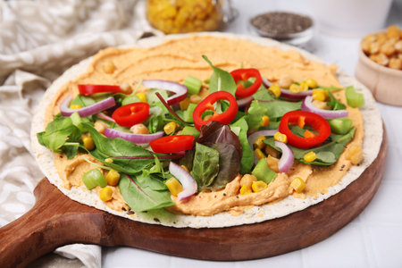 Tortilla with hummus and vegetables on table, closeupの写真素材