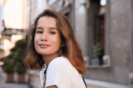 Portrait of happy young woman on city street