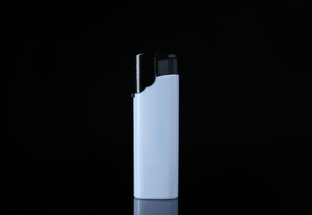 White plastic cigarette lighter on black background, closeupの写真素材