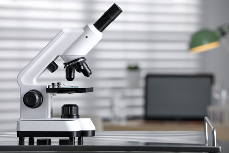 Modern medical microscope on metal table in laboratory, space for textの写真素材