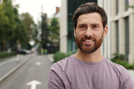 Portrait of handsome bearded man on street, space for textの写真素材
