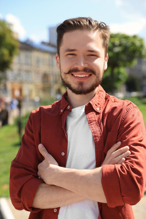 Happy man crossing his arms in the parkの写真素材