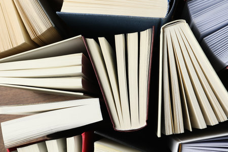 Many hardcover books as background, top viewの写真素材