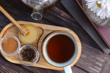 Tray with delicious tea and ingredients on wooden table, flat layの写真素材