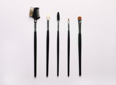 Different makeup brushes on white background, flat layの写真素材