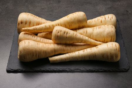 Delicious fresh ripe parsnips on black tableの写真素材