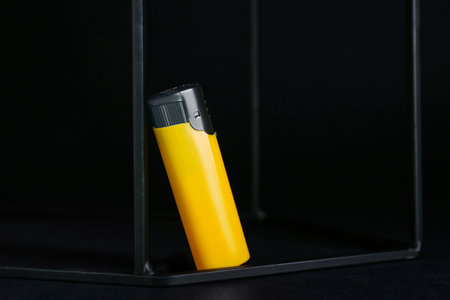 Stylish presentation of small pocket lighter on black backgroundの写真素材