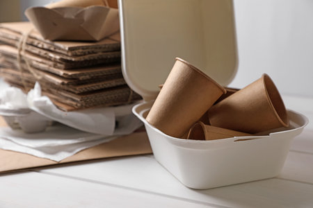 Heap of waste paper on white wooden tableの写真素材