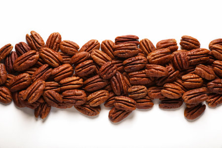Delicious fresh pecan nuts on white background, flat lay