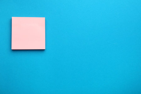 Paper note on blue background, top view. Space for textの写真素材