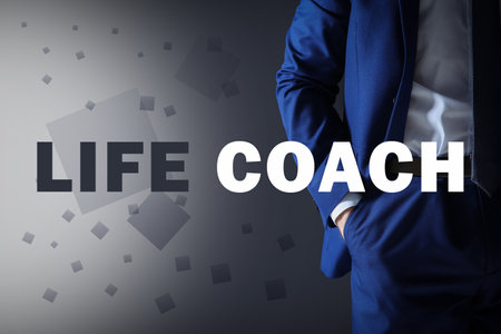 personal development concept. Businessman and phrase Life Coach on gray background, closeupの写真素材