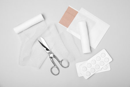 Bandage rolls and medical supplies on white background, flat layの写真素材