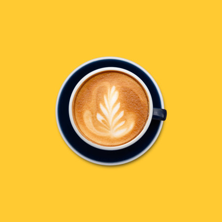 Aromatic coffee in dark blue cup on yellow background, top viewの写真素材
