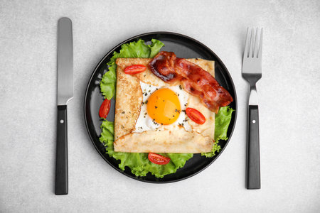 Delicious crepe with egg on light gray table, top view. Breton galetteの写真素材
