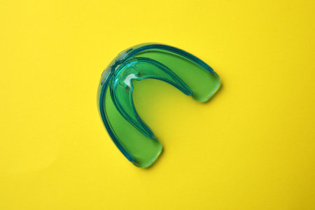 Dental mouth guard on yellow background, top view. Bit correctionの写真素材