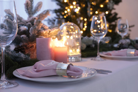 Beautiful place festive setting with Christmas decor on table indoorsの写真素材
