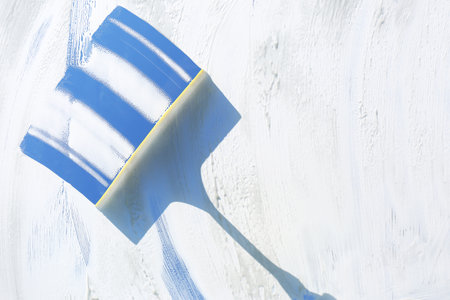 Squeegee and cleaning foam on glass, closeup
