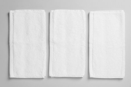 Soft folded white towels on light gray background, flat layの写真素材