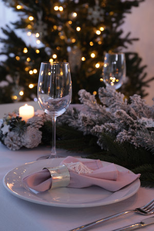 Beautiful place festive setting with Christmas decor on table indoorsの写真素材