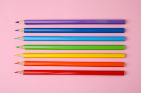 Colorful wooden pencils on pink background, flat layの写真素材